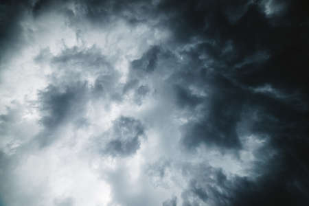 Dramatic cloudscape texture. Dark heavy thunderstorm clouds before rain. Overcast rainy bad weather. Storm warning. Natural gray background of cumulonimbus. Nature backdrop of stormy cloudy sky.の写真素材