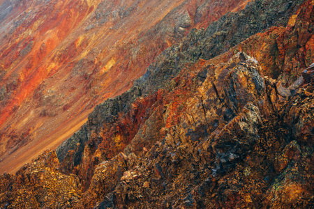 Vivid multicolor nature background of big rocky mountain with pointy rocks. Full frame surface of...