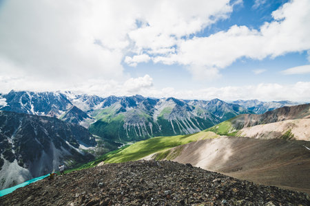Spectacular view to scenic valley with big beautiful mountain lake surrounded by giant snowy ranges...