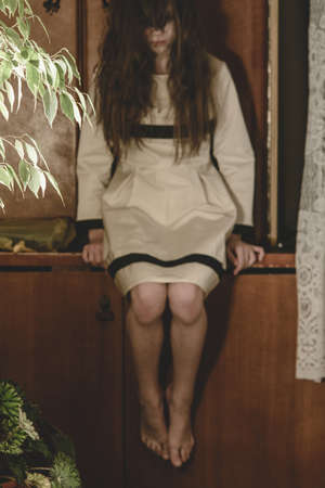 Demon possessed little girl at night. Mad scary girl at dark night. Horror background with child...