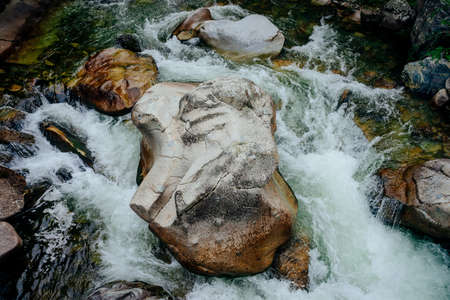 Nature background with cascades of mountain creek close-up. Scenic landscape with beautiful mountain...