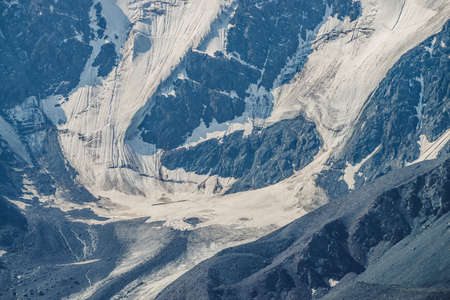 Atmospheric alpine view to giant snowy mountain wall and big glacier tongue. Amazing highland landscape with huge mountain with snow and glacier. Awesome scenery of majestic nature on high altitude.の写真素材