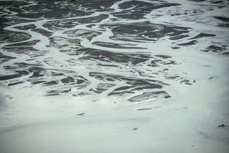 Atmospheric monochrome landscape with many channels near shallow lake. Minimal backdrop of gray...