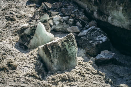 Scenic landscape with powerful mountain river beginning from glacier with ice chunks. Beautiful...