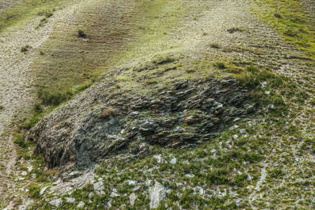 Minimalist mountain landscape with green rock steep slope. Vivid mountain scenery with grassy...