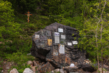 Monument to dead climbers in valley of Aktru river. Memory rock. Memorial to dead tourists in alpine camp in Aktru valley. Big memory stone. Russia, Altai Republic, Aktru mountain camp, 01 July, 2021.のeditorial素材