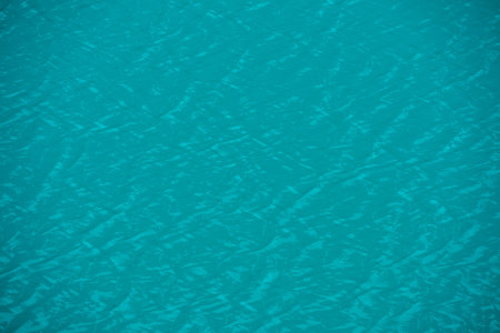 Scenic nature background of relaxing shiny ripples on calm water of alpine lake. Minimal simple fragment of meditative azure lake clear water surface. Minimalist nature texture of mountain lake water.の写真素材