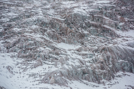 Awesome nature backdrop with glacier close-up. Beautiful abstract pattern of icefall. Natural background with mountain glacier. Amazing nature of mountains. Simple texture. White snow on glacial ice.の写真素材