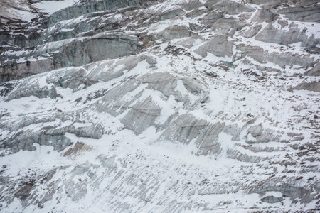 Awesome nature backdrop with glacier close-up. Beautiful abstract pattern of icefall. Natural background with mountain glacier. Amazing nature of mountains. Simple texture. White snow on glacial ice.の写真素材