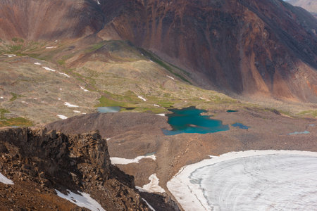 Scenic alpine landscape with azure lake in mountain valley in sunlight. Awesome mountain scenery with turquoise lake and glacier in sunshine. Colorful view to beautiful glacial lake in sunny valley.の写真素材