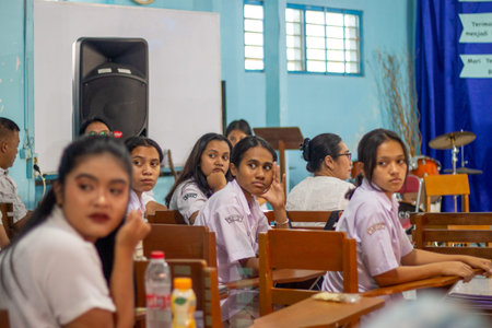 Muntilan, Indonesia - 22 Mar 2026: Indonesian high school students in white uniforms sitting in a classroom, looking attentive during an educational presentation or lectureのeditorial素材
