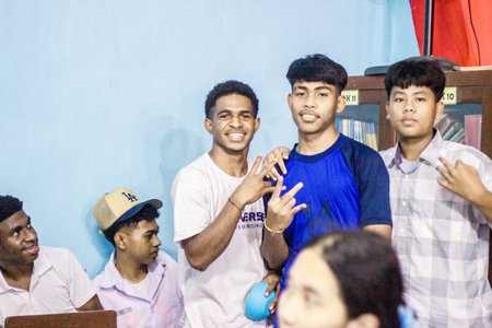 Muntilan, Indonesia - 27 Mar 2026: Multiethnic group of Indonesian teenage boys posing and smiling in a classroom setting. Diverse male students together at schoolのeditorial素材