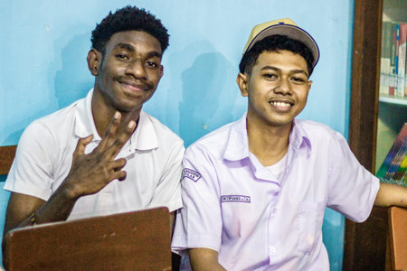 Muntilan, Indonesia - 27 Mar 2026: Two diverse Indonesian teenage boys smiling and posing in a...