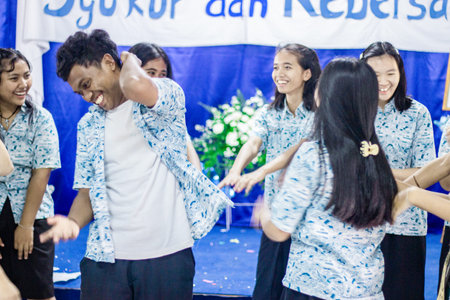Muntilan, Indonesia - 29 Mar 2026: Cheerful Southeast Asian teenagers in blue school uniforms...