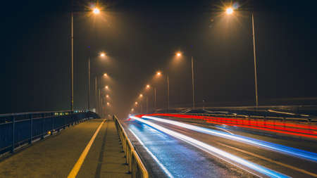 Cars crossing the Varadin Bridge on a foggy night in Decemberの写真素材