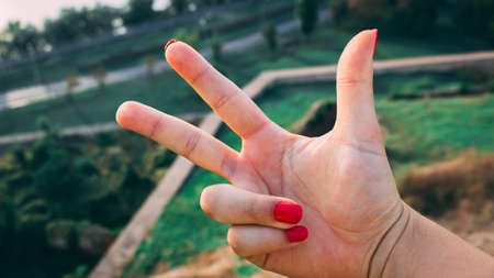 Three fingers from first person with blurred backgroundの写真素材