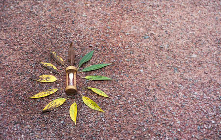 Sand running through the bulbs of an hourglass measuring the passing time in a countdown to a...