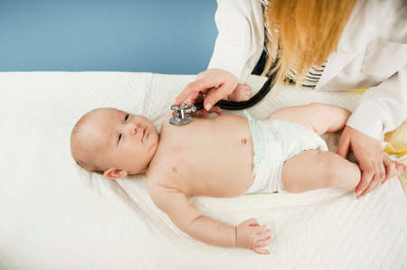 A very small child, child, lies in the doctor's office, and the doctor listens to the lungs, heart....