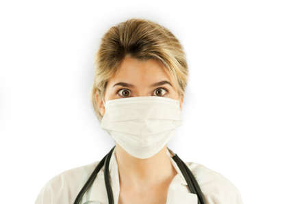 Close-up portrait of a beautiful girl doctor on a blue isolated background. Concept medicine and healthの写真素材