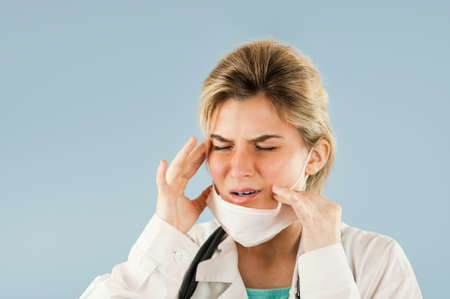 Close-up portrait of a beautiful girl doctor on a white isolated background. Concept medicine and healthの写真素材