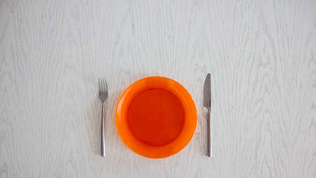 orange plate on a white tableの写真素材