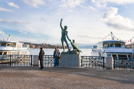 sculpture of the Ganimed on Zurich lake with ships and peopleの写真素材