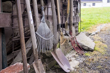 Old garden tools costing about a wooden shedの写真素材