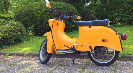 An old yellow motor scooter.の写真素材