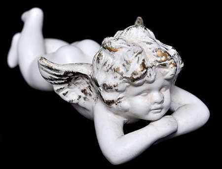 ceramic angel figure on black background 