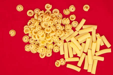 	Heap of italian pasta on red backgroundの写真素材