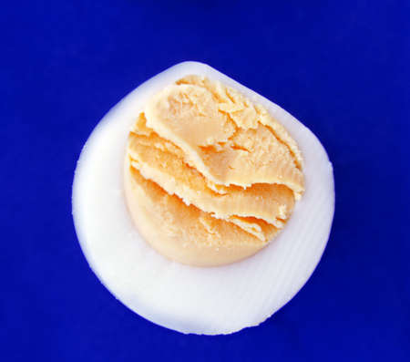 hard-boiled egg over blue background . macro