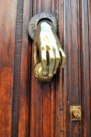 Brass knocker in a old door の写真素材