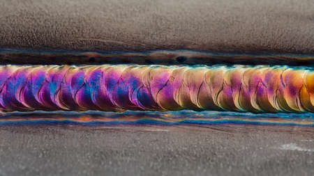Welding of stainless steel with argon arc welding. Welding TIG. Color welding seam.