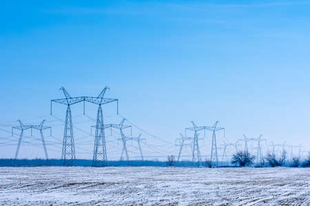 Power lines over agricultural fields covered with snow. high quality photo