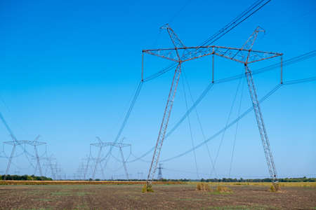 High voltage power lines. Transmission of electricity by means of poles through agricultural land....
