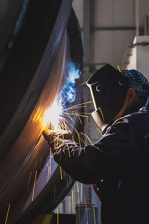 MMA welding. A welder welds large diameter pipes with manual electric arc welding. high quality...