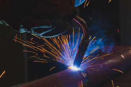 Welding torch close-up. Pipe welding by semi-automatic arc welding. MIG welding. high quality photo