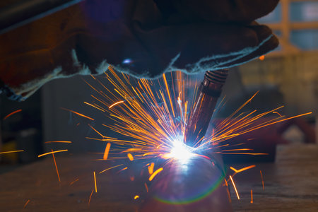 Welding torch close-up. Pipe welding by semi-automatic arc welding. MIG welding. high quality photoの写真素材