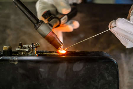 TIG welding. Welding the fuel tank of a motor pump by electric arc welding in argon shielding gas....