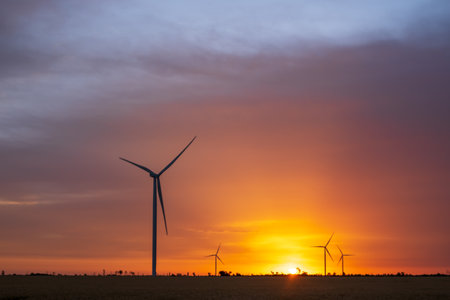 Wind turbines at dawn. Picturesque view of the wind power generator. Production of environmentally...