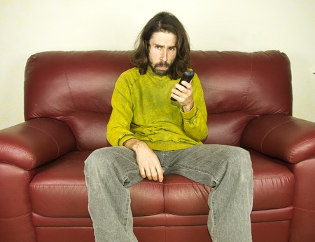 man on the couch remote controlの写真素材