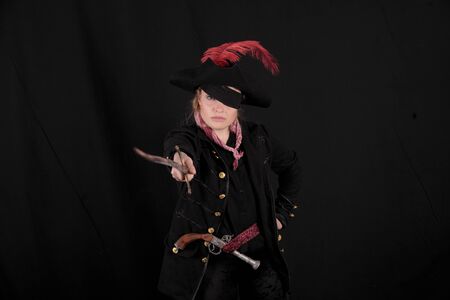 carribean girl pirate in the black background look the cameraの写真素材