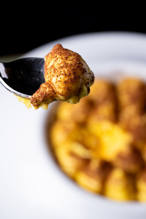 Baked potato with cheese on a white plate. Selective focus.の写真素材