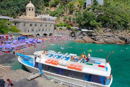 CAMOGLI, ITALY - JUILLET 16, 2019: A tourist ferry waiting in front of the Abbey of San Fruttuoso; the church is located in a small bay and it can only be reached by sea.のeditorial素材