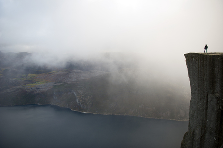 Preikestolen or Prekestolen, also known by the English translations of Preacher\'s Pulpit or Pulpit Rock, is a famous tourist attraction in Forsand, Ryfylke, Norway. It consists of a steep cliff which rises 604 metres 1982 feet above Lysefjorden, oppositeの写真素材