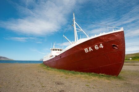 Old boat on a beach in Patreksfjordurの写真素材