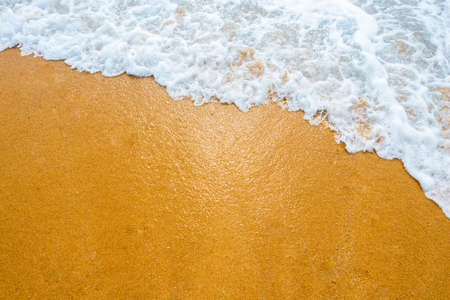 Soft blue ocean wave on clean sandy beachの写真素材