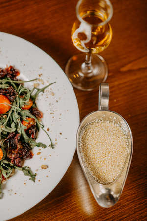Fresh salad with cucumber  tomato arugula corn and sesame dressing