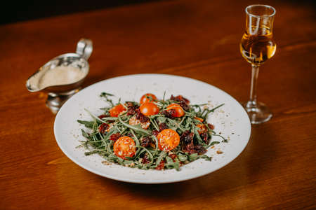 Fresh salad with cucumber  tomato arugula corn and sesame dressingの写真素材
