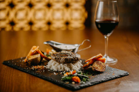 Steak with green butter mushroom sauce and vegetables
